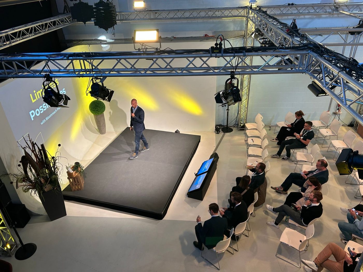 Speaker on stage at the studio with a seated audience
